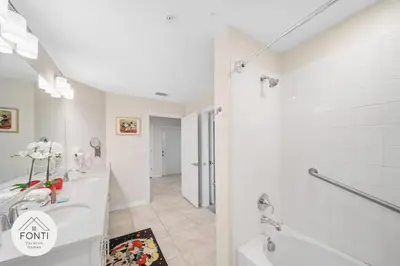 a white bathroom with a tub and a sink at Modern Storey Lake Resort Disney Orlando 3171-301 in Kissimmee