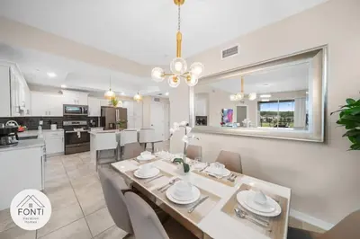 a dining room and kitchen with a table and chairs at Modern Storey Lake Resort Disney Orlando 3171-301 in Kissimmee
