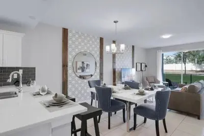 a kitchen and living room with a table and chairs at Modern Storey Lake Resort Disney Orlando 4741-104 in Kissimmee