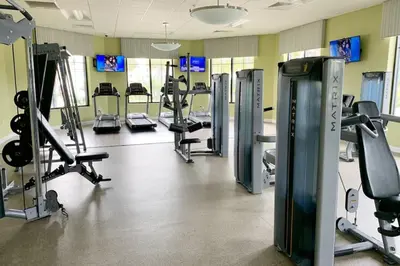 a gym with several treadmills and cardio machines at Modern Storey Lake Resort Disney Orlando 3180-104 in Kissimmee
