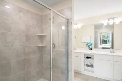 a bathroom with a shower and a sink at Modern Storey Lake Resort Disney Orlando 3180-104 in Kissimmee