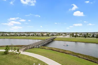 a bridge over a river with a boat on it at Modern Storey Lake Resort Disney Orlando 3180-104 in Kissimmee