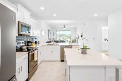 a kitchen with white cabinets and a white counter top at Modern Storey Lake Resort Disney Orlando 3191-204 in Kissimmee