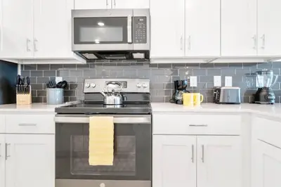 a kitchen with a stove and a microwave at Modern Storey Lake Resort Disney Orlando 3191-204 in Kissimmee