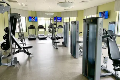 a gym with several treadmills and cardio machines at Modern Storey Lake Resort Disney Orlando 3161-305 in Kissimmee