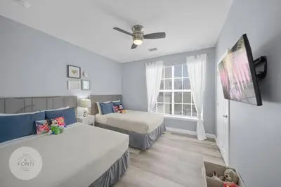 a small bedroom with two beds and a tv at Secret Lake Resort 2BR Condo Apt Disney 3176-301 in Kissimmee