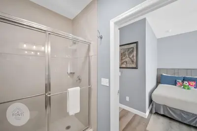 a bathroom with a shower and a bed in a room at Secret Lake Resort 2BR Condo Apt Disney 3176-301 in Kissimmee