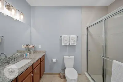 a bathroom with a toilet and a sink and a shower at Secret Lake Resort 2BR Condo Apt Disney 3176-301 in Kissimmee