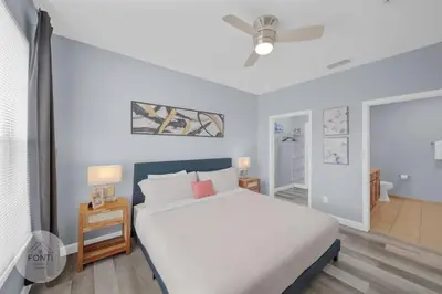 a bedroom with a white bed with a nightstand and a bed sidx sidx sidx at Secret Lake Resort 2BR Condo Apt Disney 3176-301 in Kissimmee