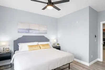 a bedroom with a white bed with a ceiling fan at Secret Lake Resort 3BR Apt Disney Orlando 3175-205 in Kissimmee
