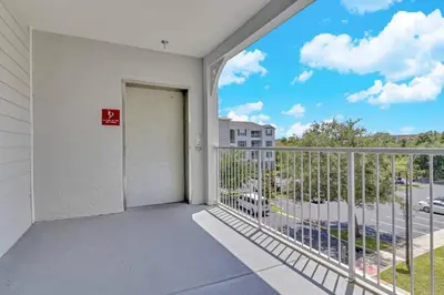 a balcony with a door and a view of a street at Secret Lake Resort 3BR Apt Disney Orlando 3175-205 in Kissimmee