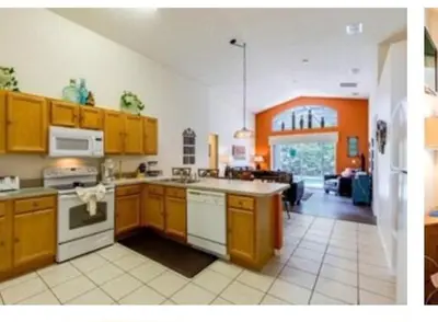 a large kitchen with wooden cabinets and an open floor plan at Make your dreams really come true in Kissimmee