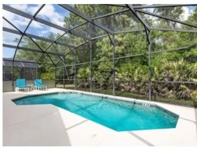 a large swimming pool with a glass roof at Make your dreams really come true in Kissimmee