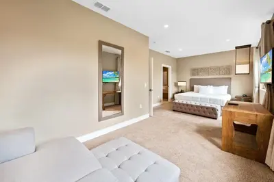 a bedroom with two beds and a living room at MAGIC VILLAGE - Near Disney - 4BDR in Orlando