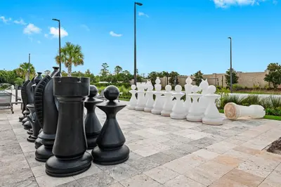 a group of black and white chess pieces on a sidewalk at MAGIC VILLAGE - Near Disney - 4BDR in Orlando