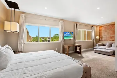 a bedroom with a large white bed and a large window at MAGIC VILLAGE - Near Disney - 4BDR in Orlando