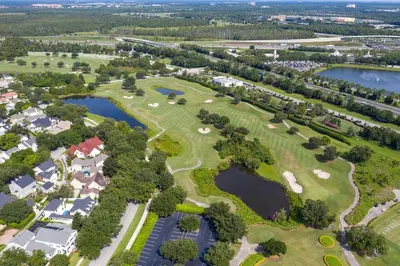 an aerial view of a park with houses and ponds at The Villa of Somerset in Kissimmee