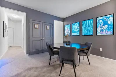 a dining room with a table and chairs at Beautiful 12Bed11.5Bath House At Bella Vida in Kissimmee