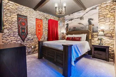 a bedroom with a bed and a stone wall at Beautiful 12Bed11.5Bath House At Bella Vida in Kissimmee