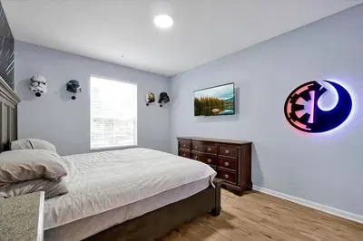 a bedroom with a bed and a dresser and a window at Windsor Hills Spacious Condo,Pool,Slides,By Disney in Orlando