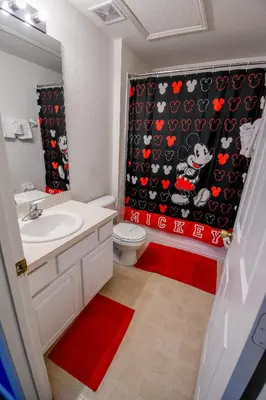 a bathroom with a toilet and a shower curtain at Casa Mickey in Orlando