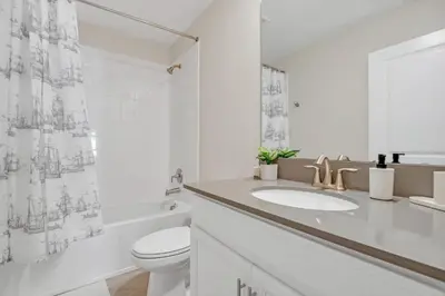 a white bathroom with a toilet and a sink at AVH-2746-SL in Kissimmee