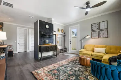 a living room with a couch and a table at 2 King En Suite Fenced Yard Pet Friendly in Orlando