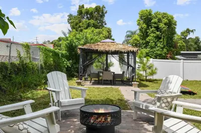 a patio with two chairs and a gazebo at 2 King En Suite Fenced Yard Pet Friendly in Orlando