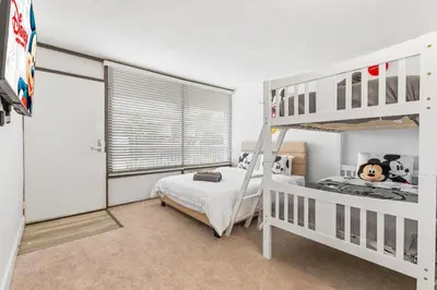 a bedroom with two bunk beds and a window at 15 Mins from Disney World l Theme Room l Pool in Kissimmee