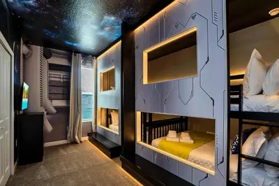 a room with two bunk beds in a house at 5BR Family Haven Near Disney with Private Pool in Kissimmee