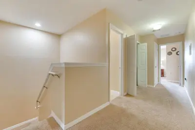 a hallway of a home with white walls at 4 Mi to Disney! Family Townhome with Pool Access in Kissimmee