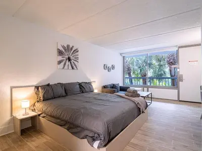 a bedroom with a large bed and a large window at Lovely 1BR Suite at Orlando with pool view in Kissimmee
