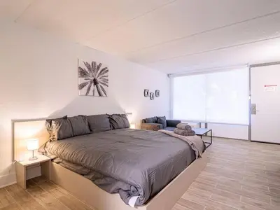 a bedroom with a large bed and a large window at Lovely 1BR Suite at Orlando with pool view in Kissimmee