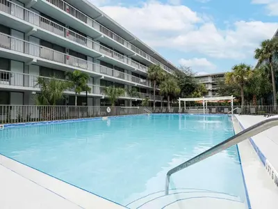 a large swimming pool in front of a building at Lovely 1BR Suite at Orlando with pool view in Kissimmee