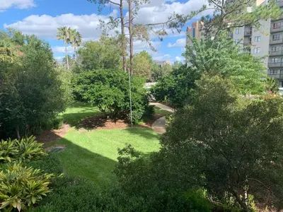 a park with green grass and trees and a swing at 12 - Universal Studios, International Dr in Orlando