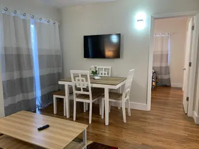 a dining room with a table and chairs and a tv at 12 - Universal Studios, International Dr in Orlando