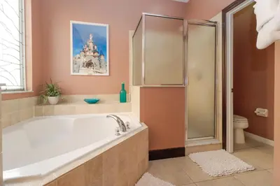 a bathroom with a large tub and a castle at Spacious Emerald Island Resort Home with Pool Spa and Resort Amenities near Disney in Kissimmee