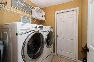 a laundry room with a washer and dryer at Spacious Emerald Island Resort Home with Pool Spa and Resort Amenities near Disney in Kissimmee