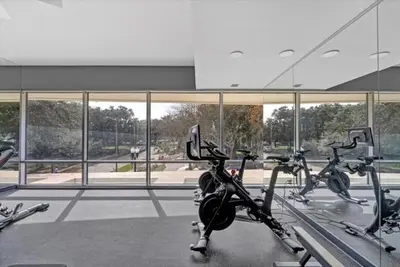 a gym with several exercise bikes in front of a building at Lake Eola Thornton Park Modern 2Bed 2Bath Secure Parking in Orlando