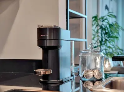 a food processor sitting on a counter with some food at Lake Eola Thornton Park Modern 2Bed 2Bath Secure Parking in Orlando