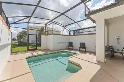 a swimming pool in a house with a glass ceiling at 5BR 10 minutes from Disney Springs SL4800 in Kissimmee