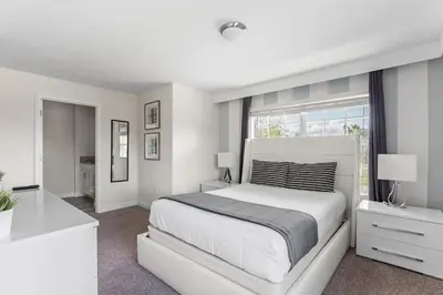 a white bedroom with a large bed and a window at 5BR 10 minutes from Disney Springs SL4800 in Kissimmee