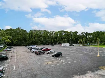 a parking lot with cars parked in it at Chilling 1BR Home in Orlando Next to Disney in Vineland