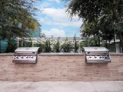 twourgers sitting on a brick wall next to a fence at Charming 1BR Home in Orlando minutes to Disney in Kissimmee
