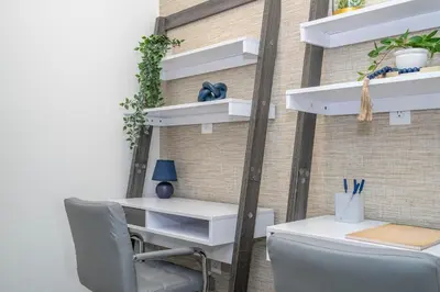 an office with white shelves and a desk at 8761 ZD - Elegant 3BR Villa in The Hub Resort - Comfort, Style, and Luxury for Your Perfect Getaway in Kissimmee