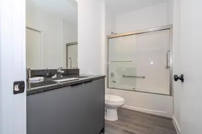 a bathroom with a toilet and a sink and a shower at 8761 ZD - Elegant 3BR Villa in The Hub Resort - Comfort, Style, and Luxury for Your Perfect Getaway in Kissimmee
