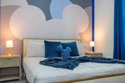 a bedroom with a bed with a teddy bear on it at 8761 ZD - Elegant 3BR Villa in The Hub Resort - Comfort, Style, and Luxury for Your Perfect Getaway in Kissimmee