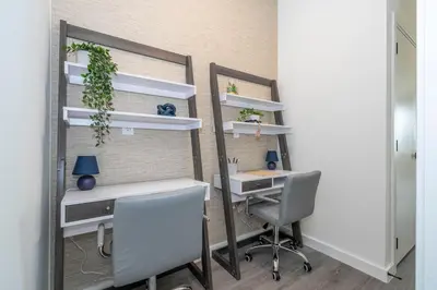 an office with a desk and two chairs and a mirror at 8761 ZD - Elegant 3BR Villa in The Hub Resort - Comfort, Style, and Luxury for Your Perfect Getaway in Kissimmee
