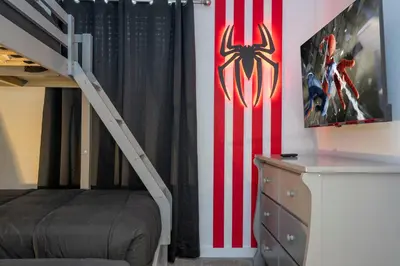 a bedroom with a staircase and an american flag wall at 8761 ZD - Elegant 3BR Villa in The Hub Resort - Comfort, Style, and Luxury for Your Perfect Getaway in Kissimmee