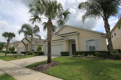 a house with palm trees in front of it at 2029 Morning in Orlando